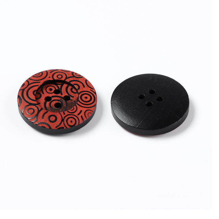 Black carved resin button with red accent